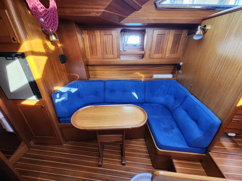 Slide: The Image of Cozy wooden yacht interior with blue cushioned seating, Regina 43 model, 2000. - 26