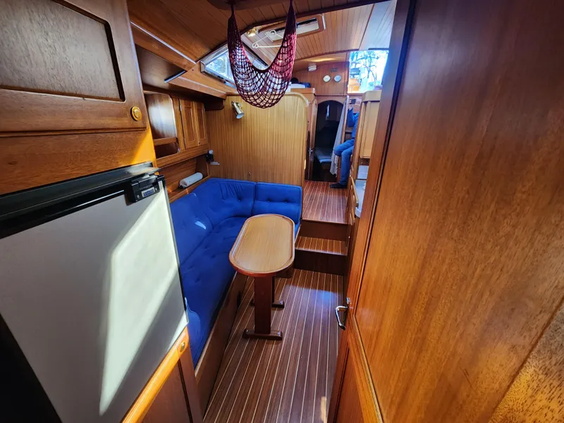 Slide: The Image of Interior of a 2000 Regina 43 sailboat with wooden finish and blue seating. - 28