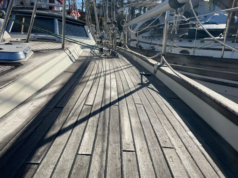 Slide: The Image of Deck of a 2000 Regina 43 sailboat with wooden planks and rigging. - 33