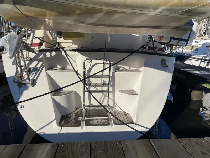 Slide: The Image of Stern view of a 2000 Regina 43 sailboat docked at a marina. - 34