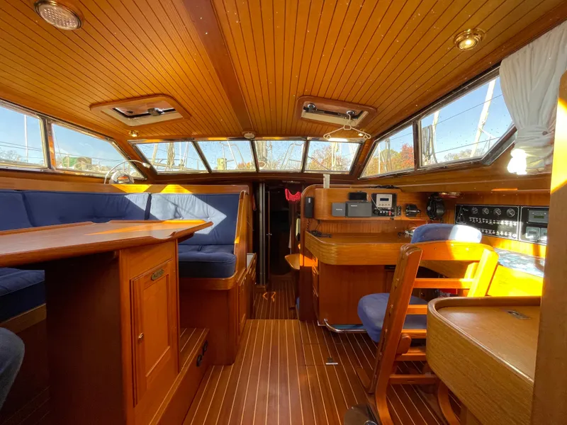 Slide: The Image of Luxurious interior of a 2000 Regina 43 yacht with wooden finishes and blue seating. - 36
