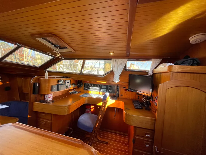 Slide: The Image of Luxurious Regina 43 yacht interior, featuring wooden furnishings and modern navigation equipment, built in 2000. - 39