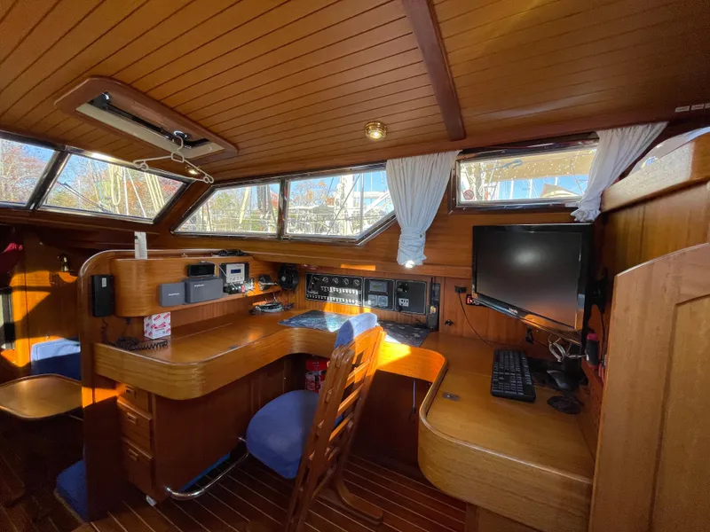 Slide: The Image of Interior of a 2000 Regina 43 yacht with wooden furnishings and navigation equipment. - 40