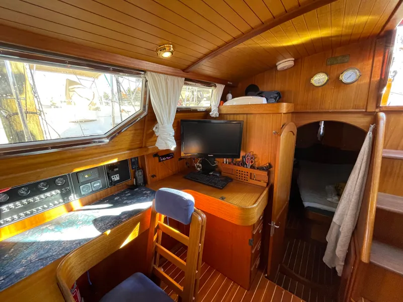 Slide: The Image of Cozy interior of 2000 Regina 43 sailboat with wooden finish, desk, and sleeping area. - 41