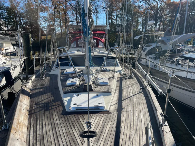 Slide: The Image of Sailboat deck view of 2000 Regina 43 model, docked among other boats. - 42