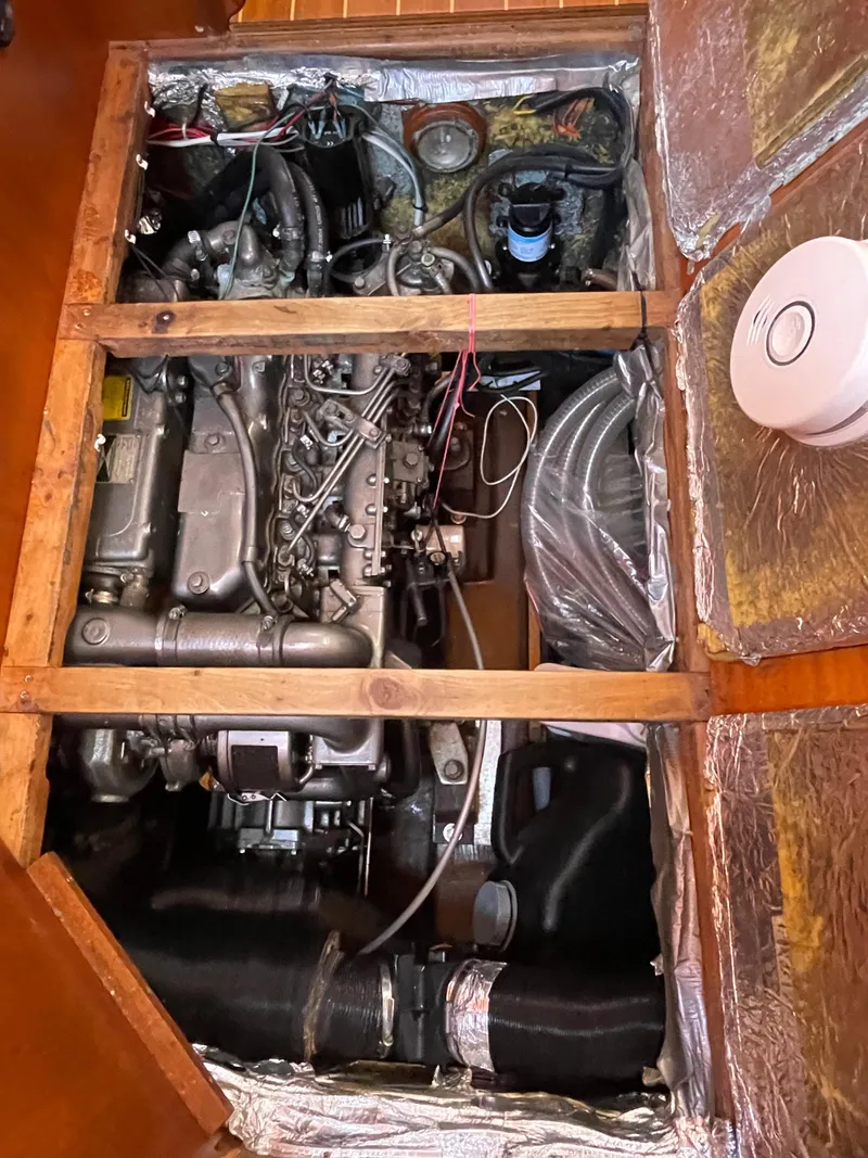Slide: The Image of Engine compartment of a 2000 Regina 43 boat, showcasing mechanical components and wiring. - 44