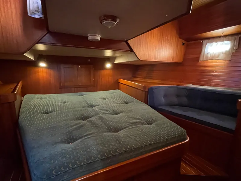 Slide: The Image of Luxurious cabin interior of a 2000 Regina 43 yacht with cozy bedding and seating. - 49