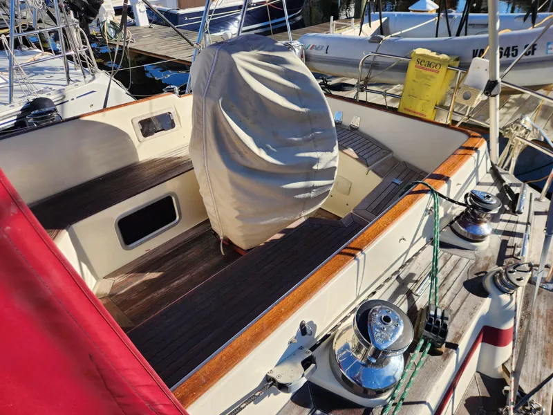 Slide: The Image of Cockpit of a 2000 Regina 43 sailboat with covered wheel and wooden deck. - 8