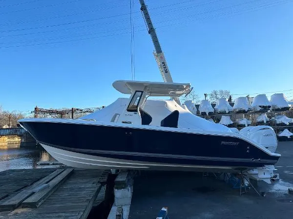 Slide: The Image of 2025 Pursuit S 268 Sport boat docked, featuring sleek design and modern amenities. - 0