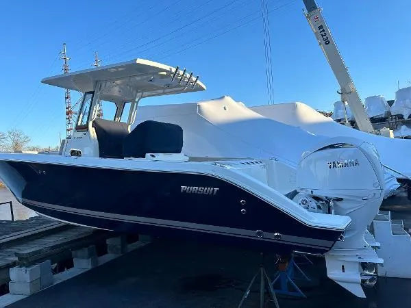 Slide: The Image of 2025 Pursuit S 268 Sport boat with Yamaha engine, docked outdoors. - 1