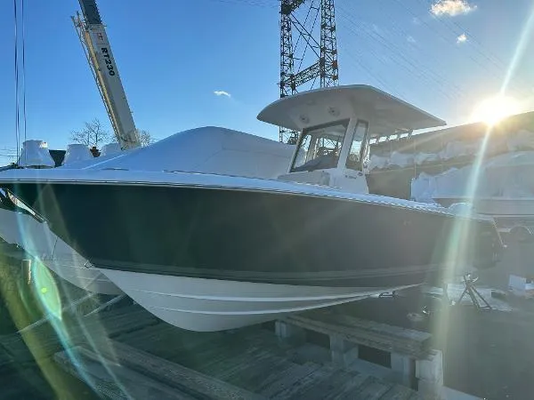 Slide: The Image of 2025 Pursuit S 268 Sport boat docked under clear sky. - 3