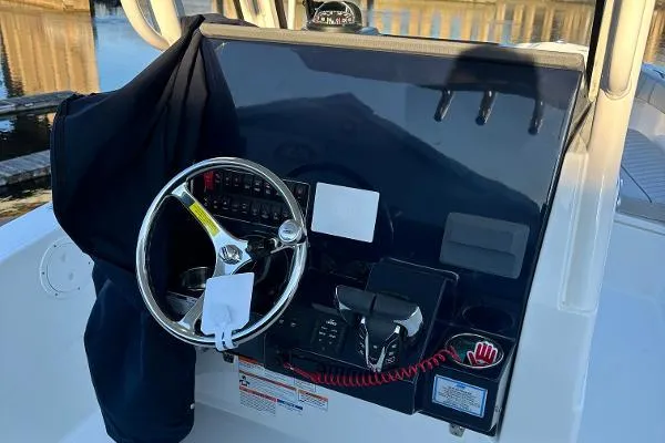 Slide: The Image of 2025 Pursuit S 268 Sport boat dashboard with steering wheel and controls. - 4