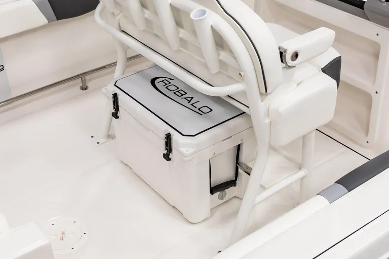 Slide: The Image of 2025 Robalo R230 Center Console boat interior with branded cooler and seating. - 12