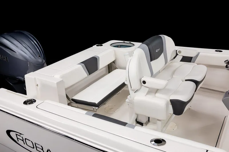 Slide: The Image of 2025 Robalo R230 Center Console boat interior with seating and engine detail. - 13