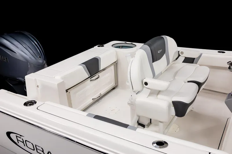 Slide: The Image of 2025 Robalo R230 Center Console boat interior with dual seating and storage compartments. - 14