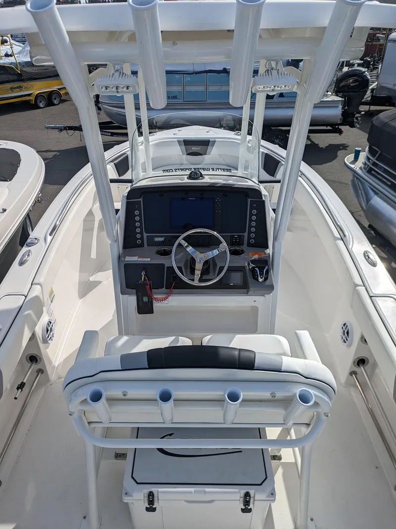 Slide: The Image of 2025 Robalo R230 Center Console boat interior with advanced navigation system and seating. - 19