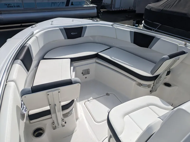 Slide: The Image of 2025 Robalo R230 Center Console boat interior with white cushioned seating. - 20
