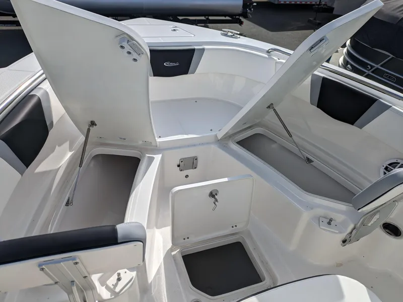 Slide: The Image of 2025 Robalo R230 Center Console boat with open storage compartments. - 23