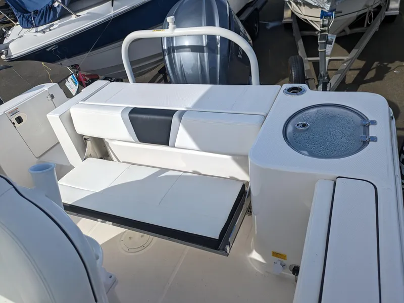 Slide: The Image of 2025 Robalo R230 Center Console boat interior with seating and storage. - 24