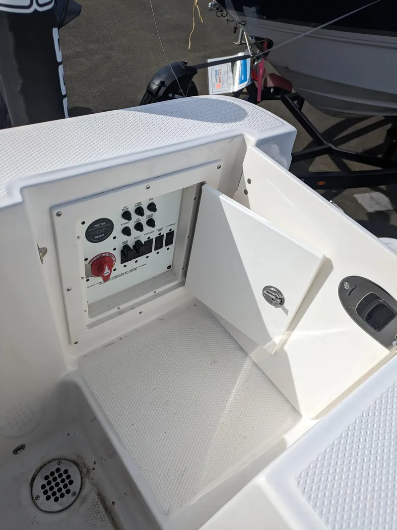 Slide: The Image of 2025 Robalo R230 Center Console boat electrical panel with open access door. - 25