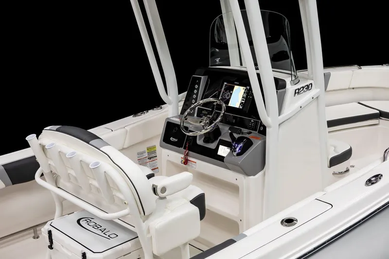 Slide: The Image of 2025 Robalo R230 Center Console boat interior with modern dashboard and seating. - 6