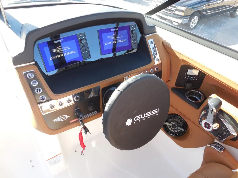Slide: The Image of 2025 Chaparral 30 Surf boat dashboard with dual displays and Gussi Italia steering wheel. - 10
