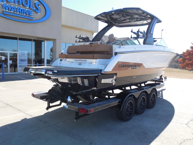 Slide: The Image of 2025 Chaparral 30 Surf boat on trailer outside dealership. - 3