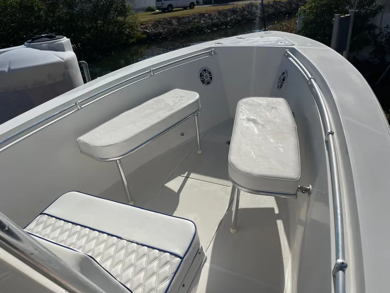 Slide: The Image of 2004 Contender 21 Open boat interior with cushioned seating and railings. - 10