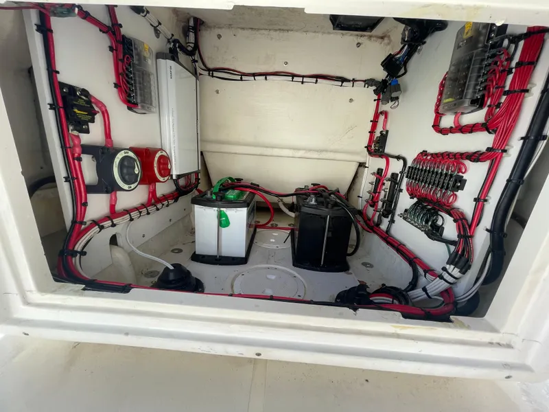 Slide: The Image of Electrical wiring and battery setup inside a 2004 Contender 21 Open boat. - 11