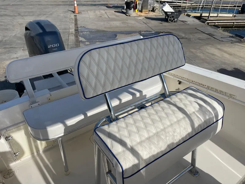 Slide: The Image of 2004 Contender 21 Open boat with cushioned seating and 200 horsepower engine. - 12