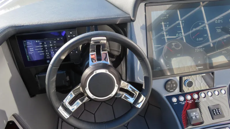 Slide: The Image of 2023 Fountain 34 Thundercat dashboard with steering wheel and digital displays. - 8