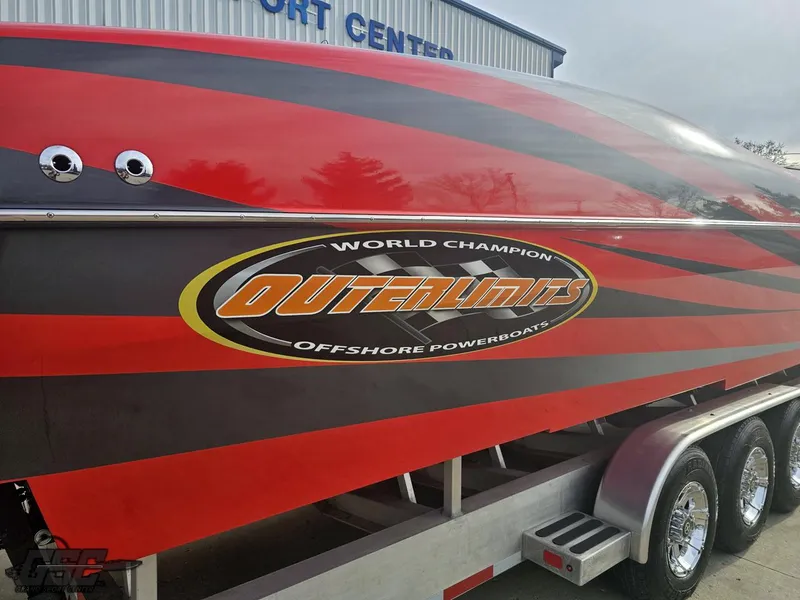 Slide: The Image of 2010 Outerlimits 52 SL powerboat with red and black design on trailer. - 10