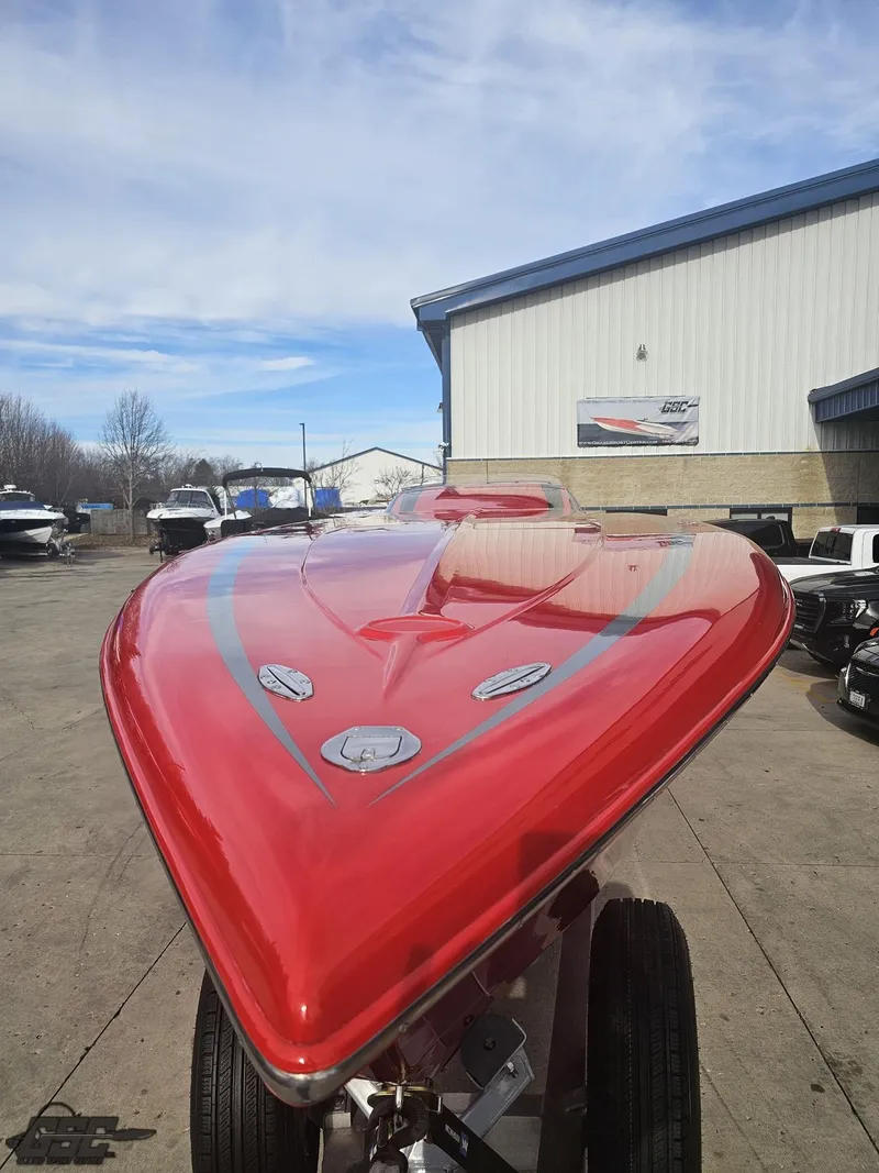 Slide: The Image of Red 2010 Outerlimits 52 SL speedboat parked outdoors, showcasing sleek design. - 23