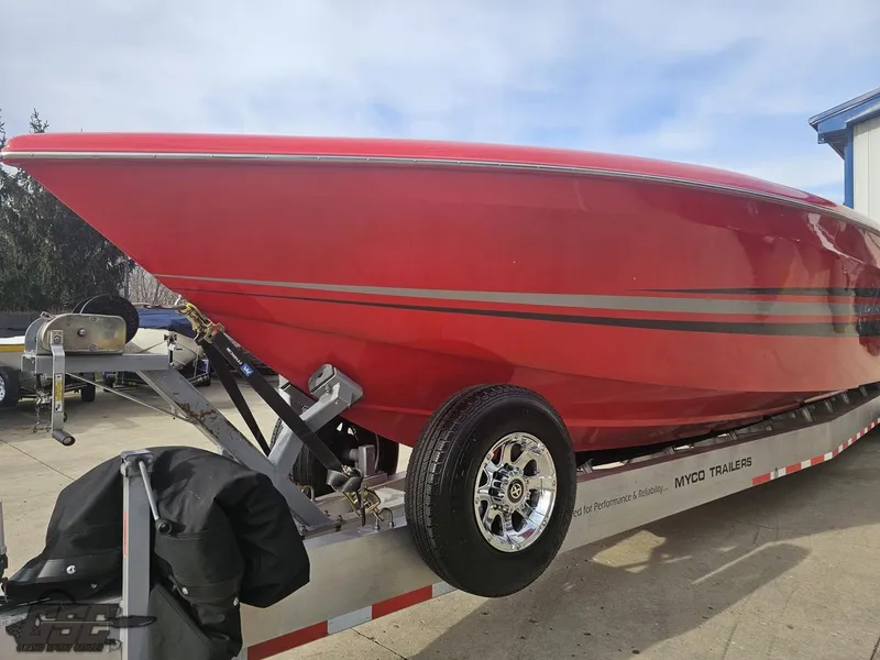 Slide: The Image of Red 2010 Outerlimits 52 SL boat on trailer, side view. - 24