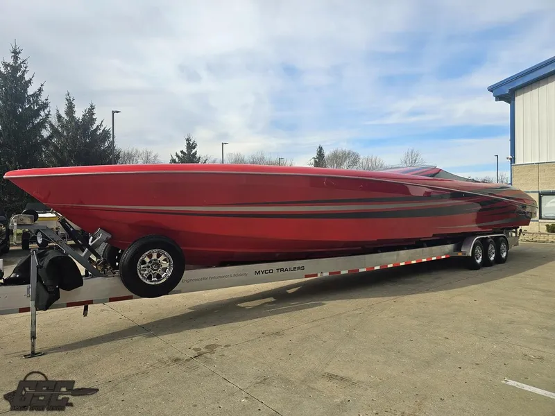 Slide: The Image of Red 2010 Outerlimits 52 SL speedboat on trailer, parked outdoors. - 25