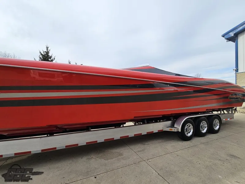Slide: The Image of Red 2010 Outerlimits 52 SL speedboat on a trailer, side view. - 29