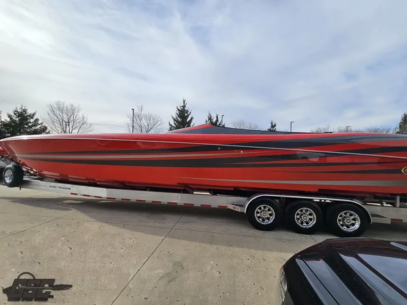 Slide: The Image of 2010 Outerlimits 52 SL powerboat on trailer, vibrant red and black design. - 33