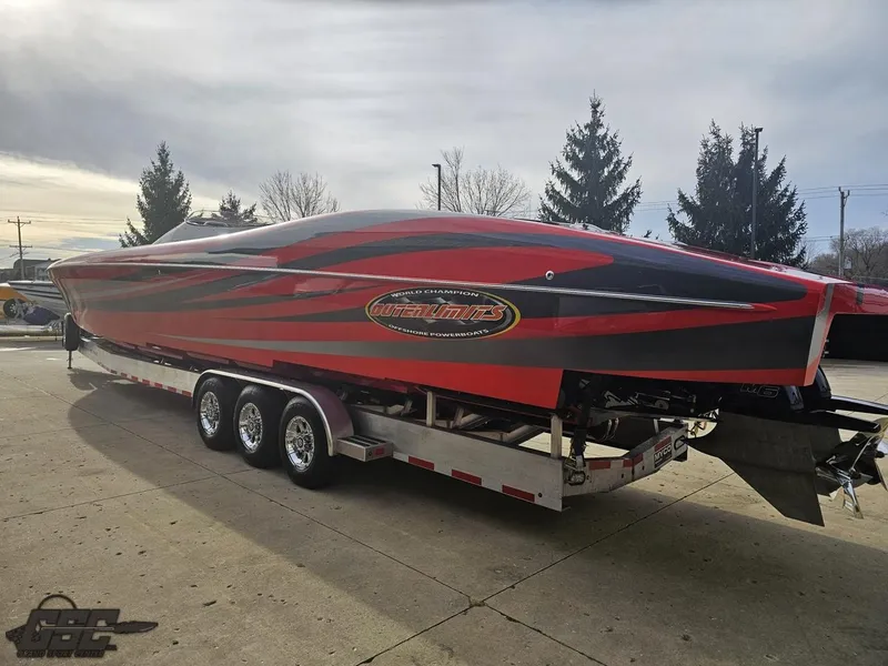 Slide: The Image of 2010 Outerlimits 52 SL powerboat on trailer, red and black design, parked outdoors. - 35