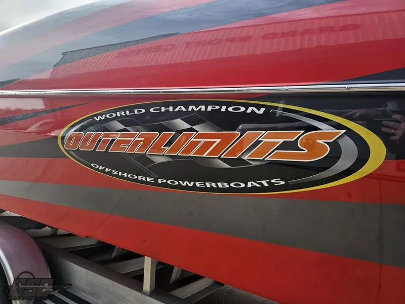 Slide: The Image of 2010 Outerlimits 52 SL powerboat with bold logo and red design. - 36