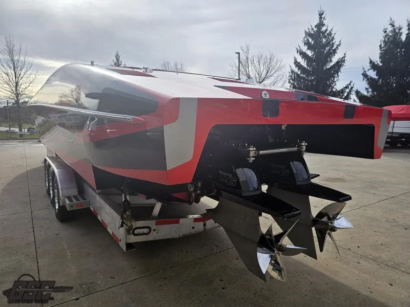 Slide: The Image of 2010 Outerlimits 52 SL powerboat on trailer, showcasing sleek design and powerful engines. - 37