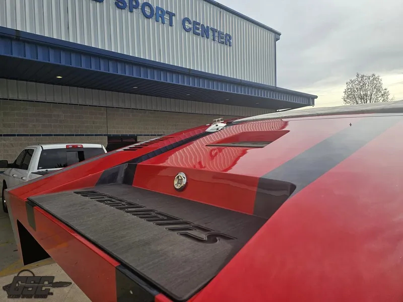 Slide: The Image of 2010 Outerlimits 52 SL boat at a sport center, rear view. - 42