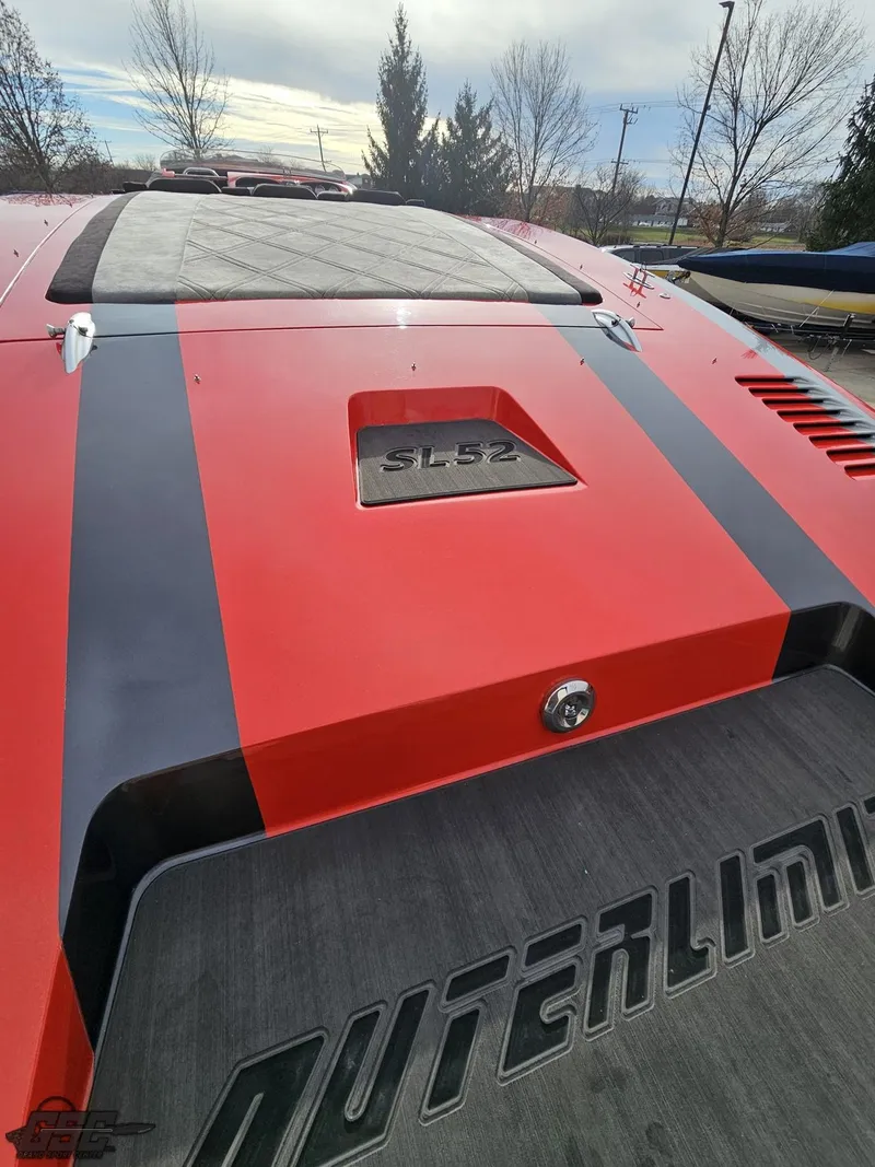 Slide: The Image of 2010 Outerlimits 52 SL boat with red and black design, rear view. - 46