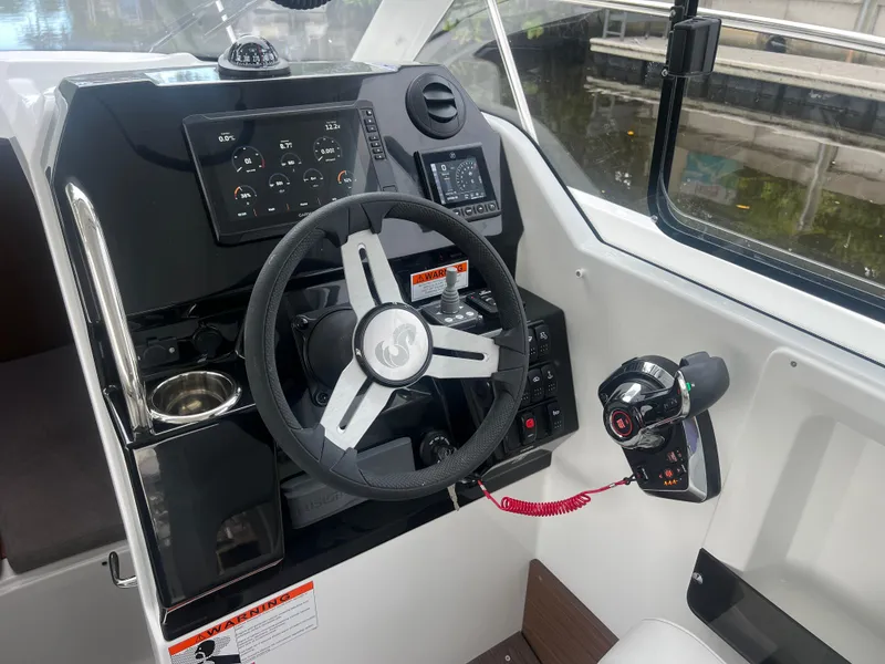 Slide: The Image of 2025 Beneteau Antares 8 helm with modern controls and navigation instruments. - 11