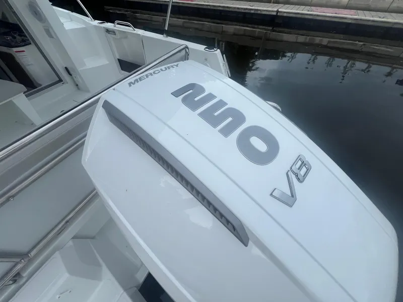 Slide: The Image of 2025 Beneteau Antares 8 with Mercury V8 outboard engine at dockside. - 14