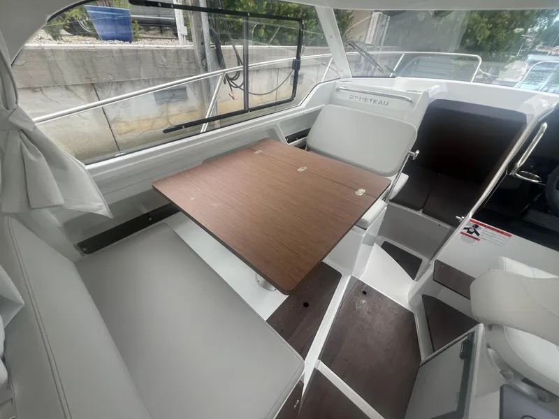 Slide: The Image of Interior of 2025 Beneteau Antares 8 boat with seating and wooden table. - 9