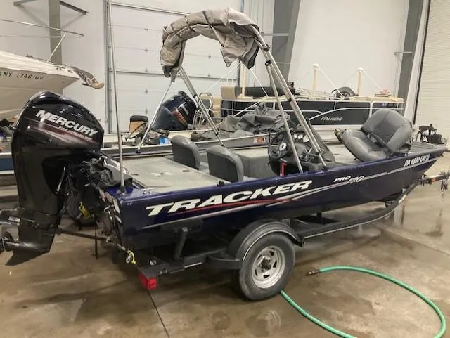 The Image of 2019 Tracker Pro 170 boat with Mercury outboard motor in a garage. - 0