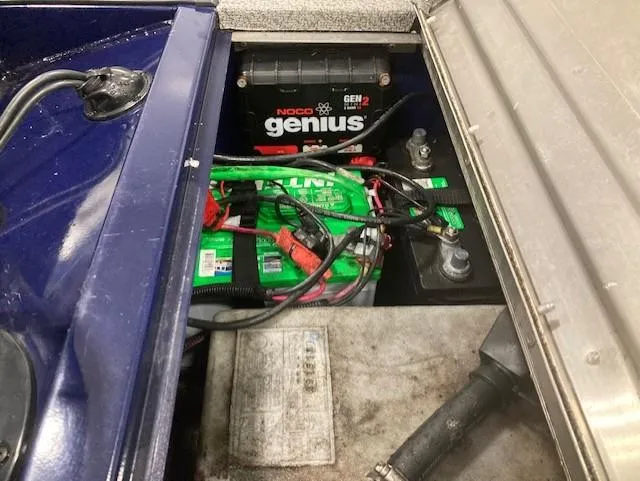 Slide: The Image of 2019 Tracker Pro 170 battery compartment with Noco Genius charger and wiring. - 6