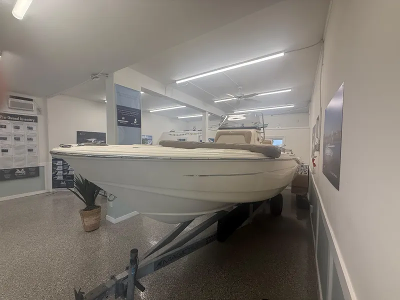 Slide: The Image of 2024 Scout 175 Sportfish boat displayed indoors on a trailer. - 10