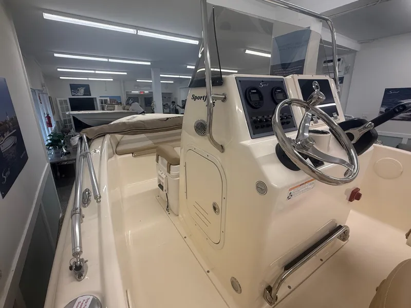 Slide: The Image of 2024 Scout 175 Sportfish boat interior with steering wheel and control panel. - 9