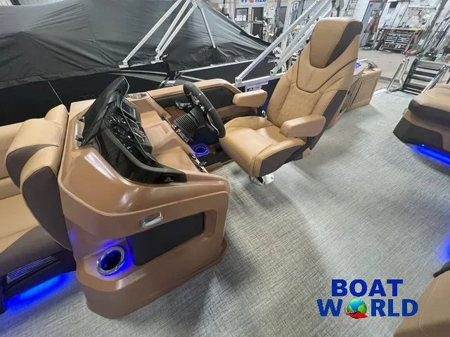 Slide: The Image of 2025 Tahoe LTZ 2385 Cruise Tritoon interior with luxury seating and modern dashboard. - 10